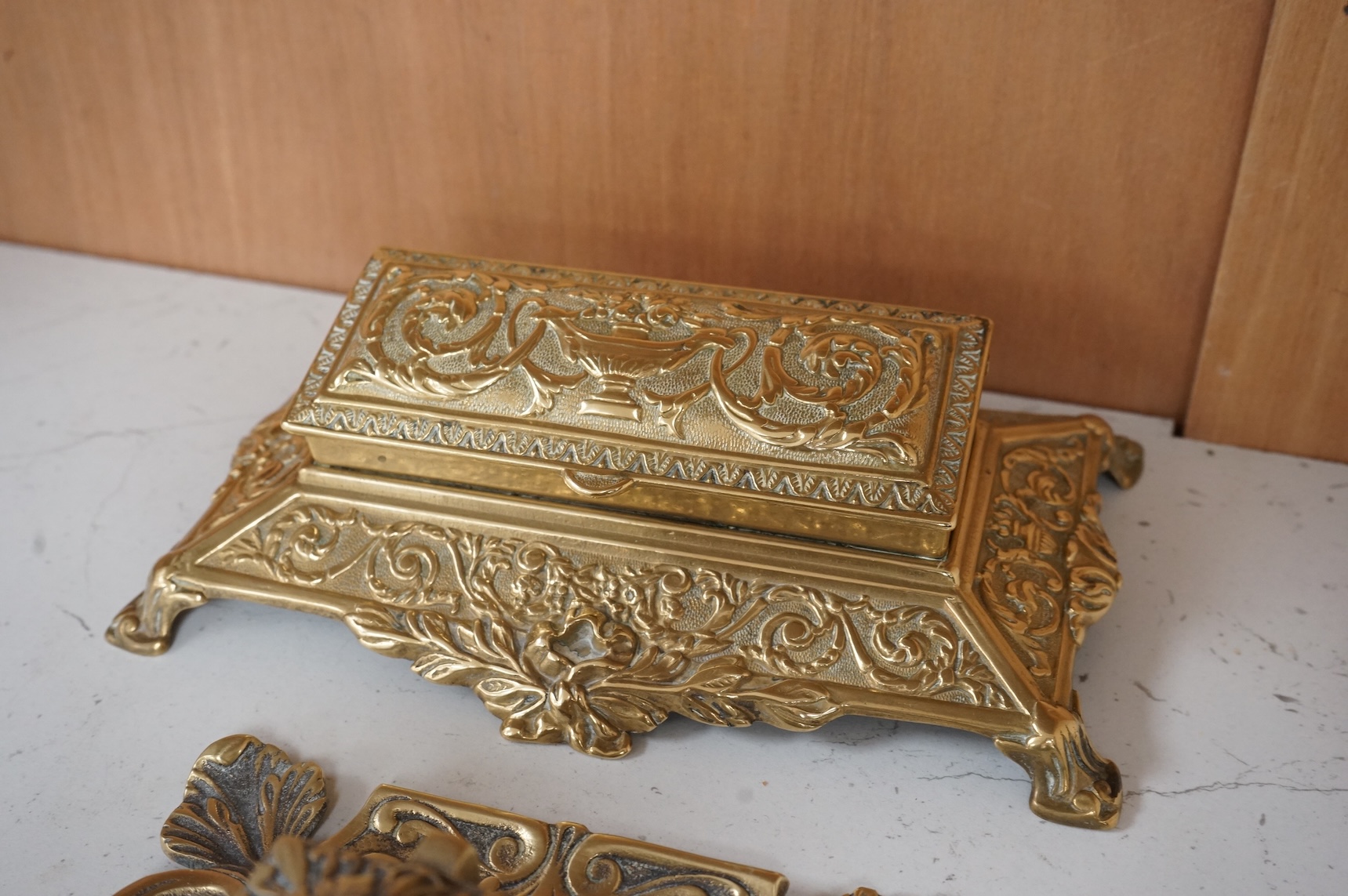 A decorative brass stamp box and a similar inkwell, largest 22cm wide